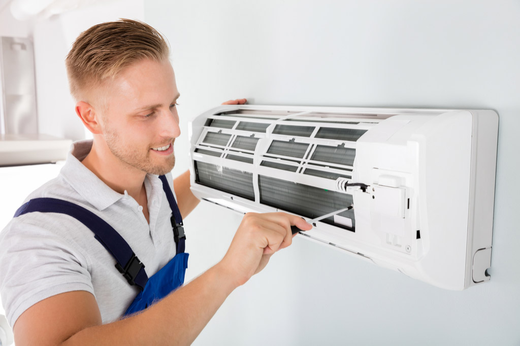 HVAC technician performing ductless air conditioning maintenance in Frederick
