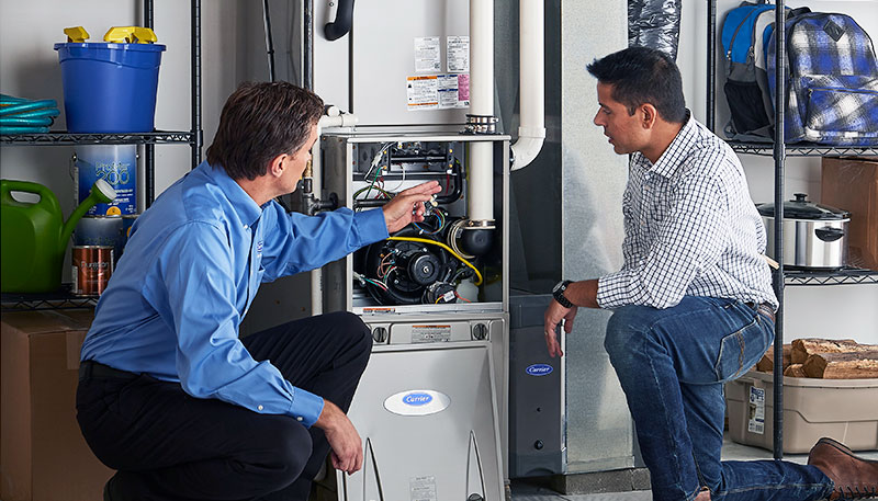 HVAC technician evaluating a furnace for repair or replacement in Frederick