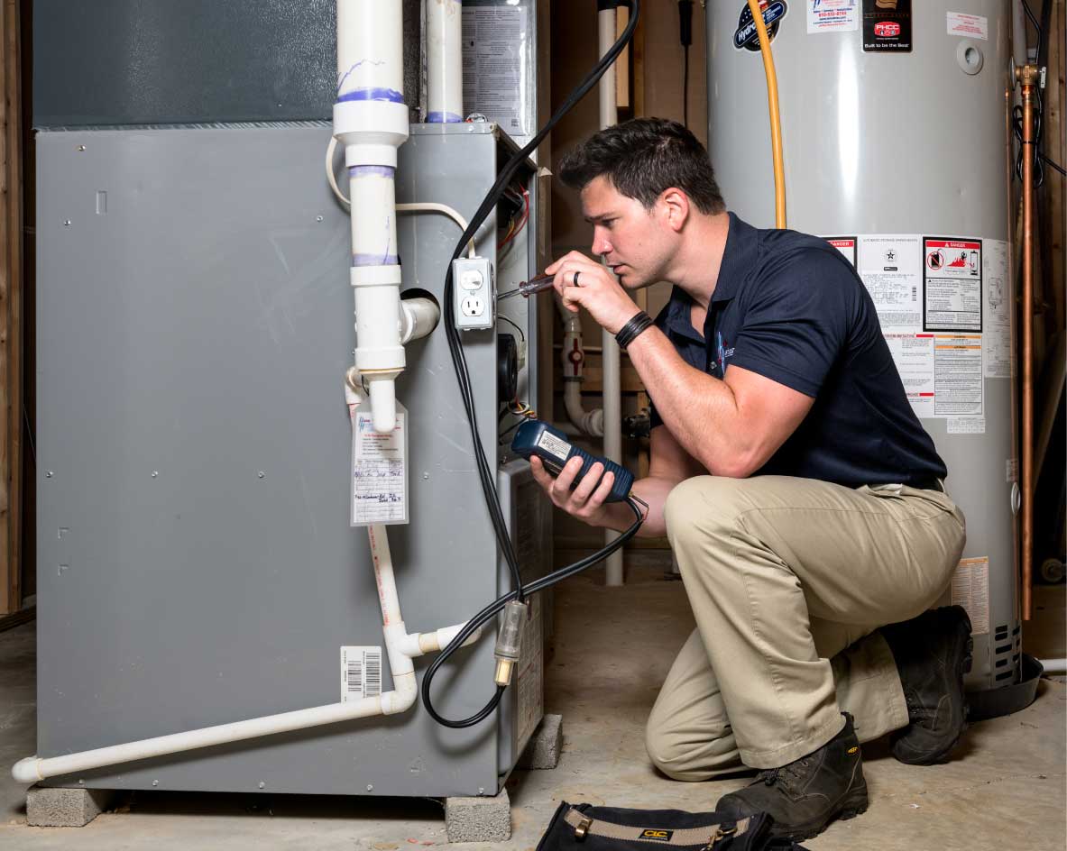 HVAC technician performing a furnace tune-up in Frederick