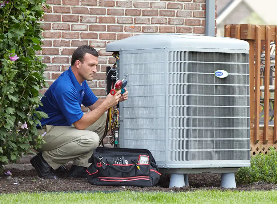 HVAC technician inspecting an outdoor air conditioning unit in Frederick